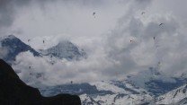 Paragliding race over the Eiger from a hanging belay in Hintesberg, Grindelwald