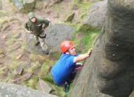 Kev climbing at Stanage, even putting the tongue to good use.